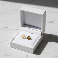 Gold rose knot studs in jewelry box