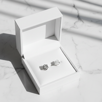 Silver rose knot studs in jewelry box